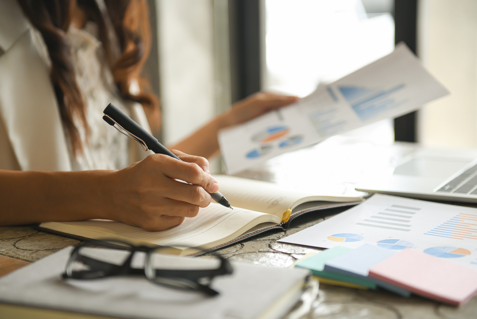 Business women are checking the company performance chart.