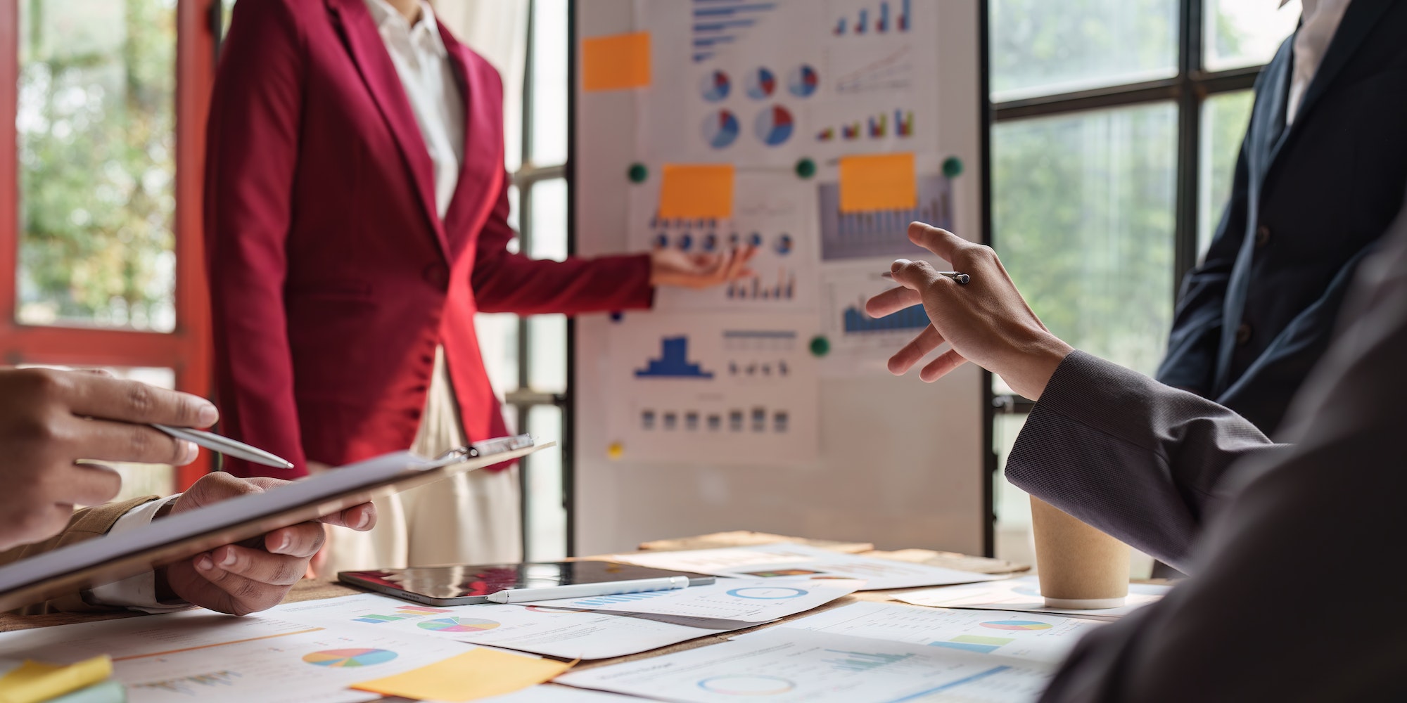 Close up of Diverse colleagues gather brainstorm discuss financial statistics at office meeting