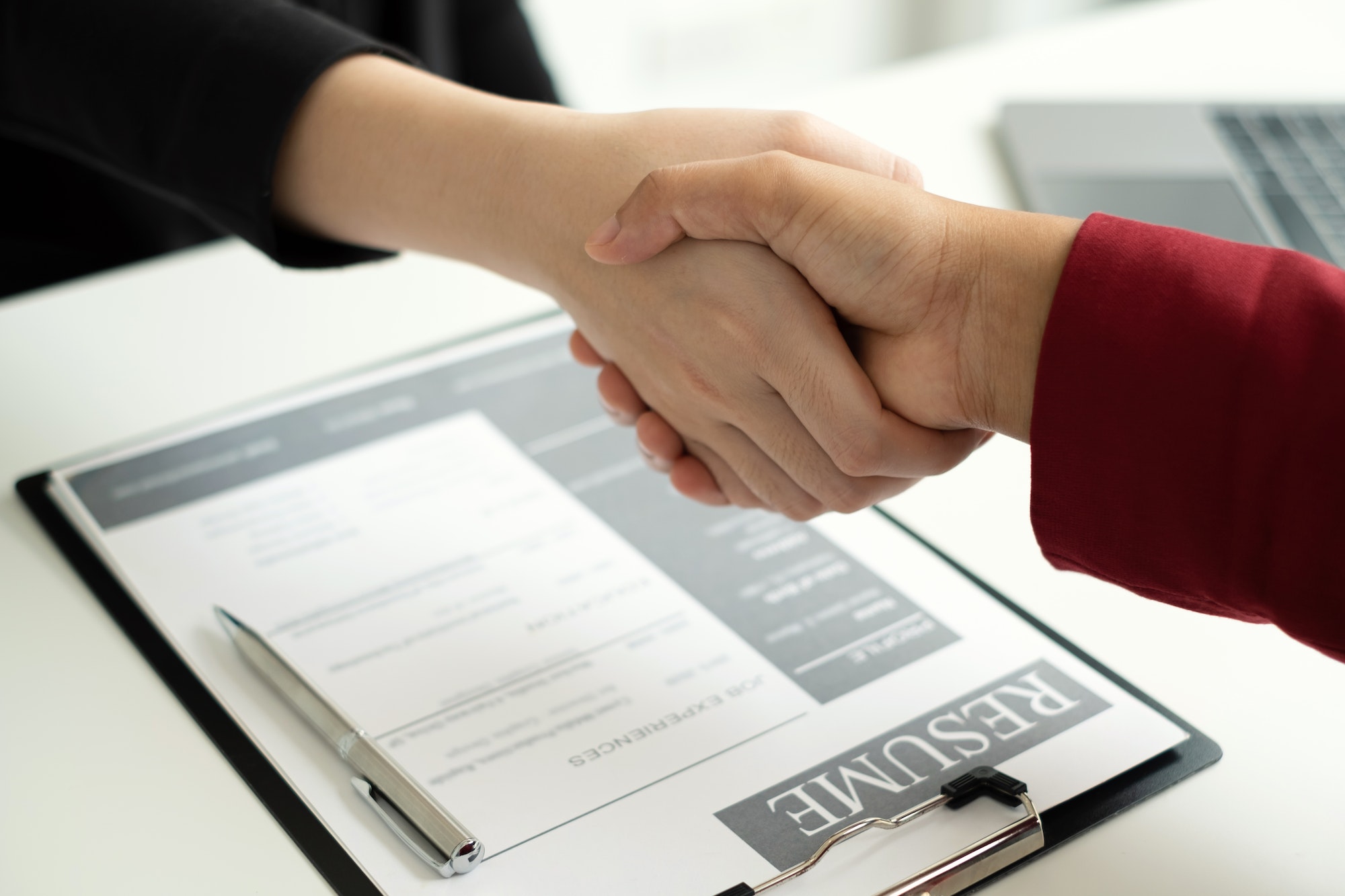 Employer shake hand with job applicants congratulates and welcomes new hires after successful